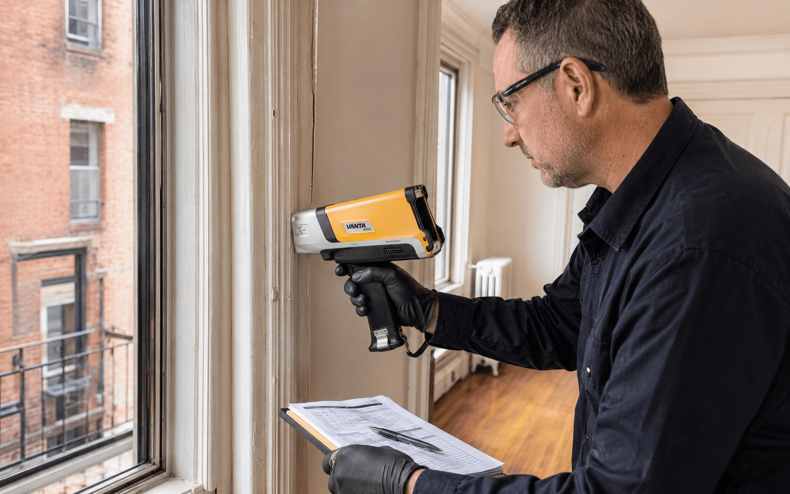 Evident Vanta handheld XRF analyzer used on painted apartment trim during a NYC lead paint inspection.
